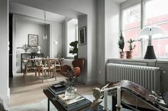 a living room filled with furniture next to a table and chair in front of a window