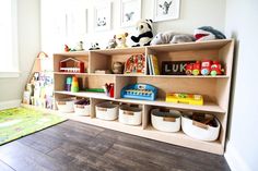 a child's playroom with toys and bookshelves on the shelves in it