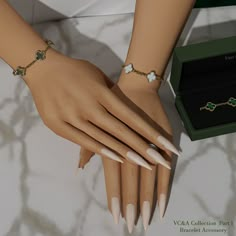 two female hands with bracelets on them next to a green box and white nails