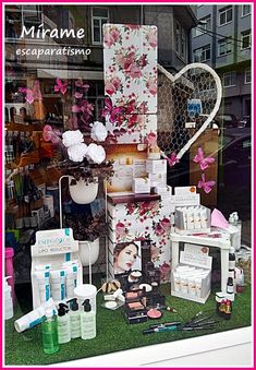 a display in a store window filled with lots of beauty products and personal care items