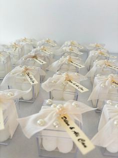 small white boxes with tags and bows on them