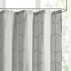 a white curtain hanging in front of a window