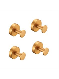 three brass colored knobs on a white background