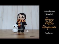 a harry potter amigurmi doll with a white teddy bear sitting next to it