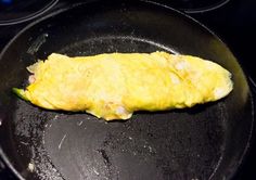 an omelet is being cooked in a skillet