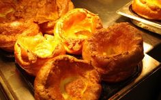 several baked pastries sitting on top of a metal tray next to eachother