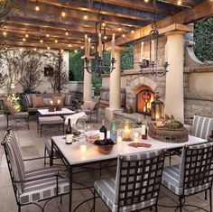 an outdoor dining area is lit up with candles