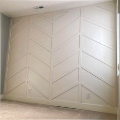 an empty room with white paint on the walls and carpeted flooring in front of it