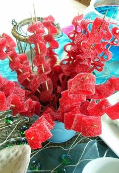 red candy sticks are arranged in the shape of letters on a table with other items