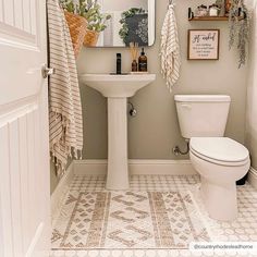 a white toilet sitting next to a bathroom sink