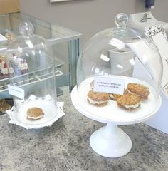 some food is under a glass clochet on a counter top in a store