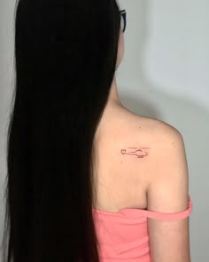 the back of a woman's shoulder with a tattoo on it