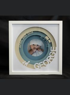 a white frame with a baby's photo in the center and words on it