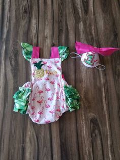 "This outfit is meant to get messy! Great for first birthday cake smash party or photo shoot. Outfit includes one piece romper with flamingo fabric with white backing, green tropical leaf ruffles, hot pink straps with leaf shoulder ruffles that loop through on the back and tie for a long bow, and \"one\" embroidery in gold with a pineapple for the \"o\". The hat is made with coordinating fabric, hot pink bow and leaf and gold 1. Leaf fabric can be changed into solid aqua color as well, just mess Playful Pink Crafts For Gifts, Flamingo First Birthday Party, Wild One First Birthday Cake, Flamingo Birthday Decorations, Wild One First Birthday, Flamingo Fabric, First Birthday Cake Smash, Flamingo Birthday Party, Flamingo Tropical