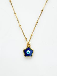 How adorable is this charm? Handpainted and one of a kind with a shimmery blue touch. So dainty and feminine while keeping you fashionably protected from the evil eye. The evil eye design is handpainted adorned on a tarnish resistant 18inch satellite style stainless steel chain.  Comes with my custom storage jewelry pouch to store.  Each design is one of a kind. custom painted in Istanbul. Adjustable Blue Necklace With Flower Charm, Blue Bohemian Necklace With Flower Charm, Blue Pendant Necklaces With Flower Charm, Blue Pendant Necklace With Flower Charm, Blue Charms Necklaces For Good Luck, Blue Charm Necklaces For Good Luck, Good Luck Blue Charms Necklaces, Blue Evil Eye Jewelry As Gift, Blue Evil Eye Jewelry Gift