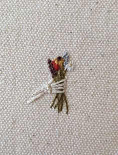 a bunch of flowers sitting on top of a white carpet next to a pair of scissors