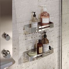 two shelves with soap, lotion and hand sanitizers on them in a bathroom