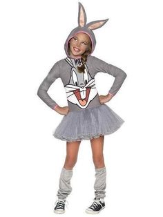 a girl in a bunny costume posing for the camera with her hands on her hips