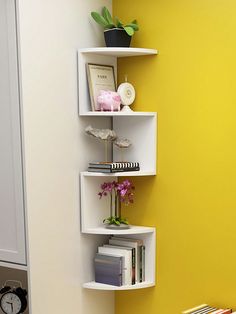 a corner shelf in the corner of a room with books on it and a clock