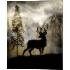 the silhouette of a deer stands in front of a mountain range with trees and fog