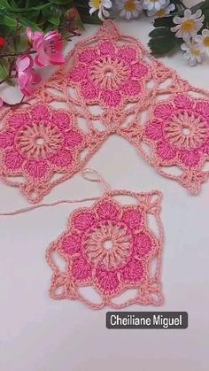 crocheted doily with flowers in the background