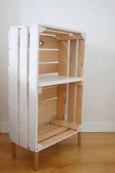 a white cabinet with wooden shelves on it