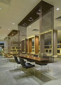 an empty conference room with many chairs and lights on the walls, along with a long table