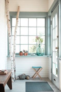 an image of a room with white walls and wood flooring on the phone screen