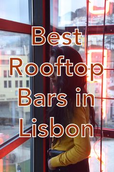 a woman standing in front of a window with the words best rooftop bars in lisbon