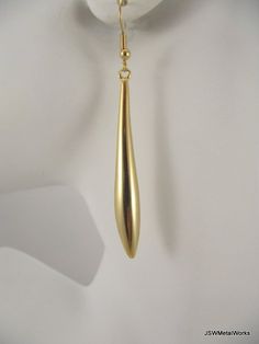 Long, simple and elegant.  What a perfect accent to any outfit.These gold plated earrings are so sophisticated and sleek - and so much fun to wear!  They are finished off with gold plated ear wires.  The ear wires can be switched out to stainless steel, for those with sensitive ears, or gold plated clip-ons at no additional charge. Simply select your option before adding to your cart.Total height from top of ear wire to bottom of the drop is approximately 2.75 inches.Width at the widest point of Gold Drop Linear Earrings For Party, Gold-plated Teardrop Earrings For Party, Minimalist Formal Earrings With French Hook, Gold Brass Long Drop Teardrop Earrings, Minimalist French Hook Earrings For Formal Occasions, Gold Minimalist Drop Earrings, Elegant Matte Gold Earrings For Party, Elegant Matte Gold Party Earrings, Minimalist Teardrop Earrings With Ear Wire For Formal Occasions