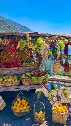 an outdoor fruit stand with lots of fruits