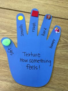 a hand made out of blue paper that says texture how something feels on the palm