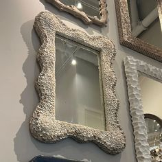 there are three mirrors on the wall next to each other