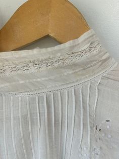 Victorian White Eyelet Shirt in really excellent condition considering it is antique. So cute! Featuring delicate lace on cuffs in a No wear visible aside from two small discoloration speckles on the collar (see photos). Unmarked size, fits many! May best fit xs/s. Wash separately in slightly warm water. Approximate Measurements: Length: 17" Underarm to underarm: 20" Vintage White Top With Lace Collar For Daywear, White Lace Trim Shirt For Daywear, White Shirt With Lace Trim For Daywear, Vintage Cotton Blouse With Lace Cuffs, Classic Summer Shirt With Lace Trim, White Shirt With Lace Collar For Daywear, Victorian Cotton Tops With Lace Trim, Victorian Cotton Top With Lace Trim, Vintage Tops With Lace Cuffs And Ruffled Collar