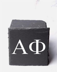 a black block with white letters and the letter qa on it's side