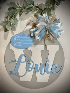 a paper cutout with the word love hanging from it's center piece, surrounded by greenery