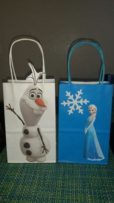 two frozen princess bags sitting on top of a table