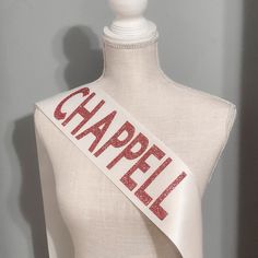 a white mannequin with a red word that says chapell on the side