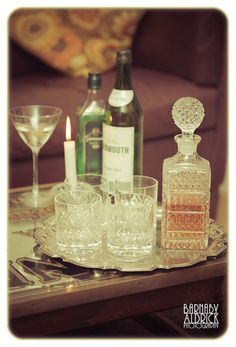 an assortment of liquor bottles and glasses on a tray