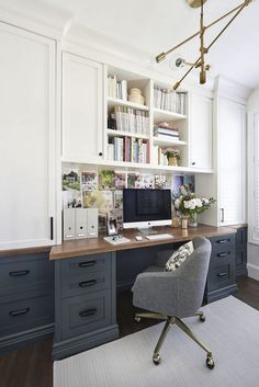 a home office with built - in bookshelves, desk and chair is shown