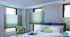 a bedroom with green shades on the windows, and a bed in front of it