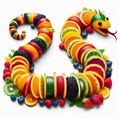 a very colorful snake made out of fruit