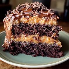 a piece of cake on a plate with chocolate frosting and caramel toppings