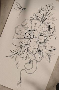 a drawing of flowers and a dragon on paper