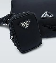 This black crossbody bag from Prada is made from technical nylon featuring a zipped top fastening, leather trims and a miniature pocket on the strap..Closure: zipped top.Color of fastening: silver.Color of strap: black.Comes with dust bag.Internal details: fabric lining.Made in Italy.Material: fabric, leather.Adjustable shoulder strap, Detachable shoulder strap.Height 17,5cm-7'.Width 25cm-10'.Min. depth 3,5cm-1.5'.Max. depth 7cm-3'.Pendant length 10,5cm-4'.Pendant width 7,5cm-3'.Min. length shou Black Functional Shoulder Bag With Logo Hardware, Business Black Shoulder Bag With Logo Strap, Prada Nylon Crossbody Bag, Nylon Crossbody Bag, Black Crossbody Bag, Prada Nylon, Prada Bags, Prada Crossbody, Men's Bags