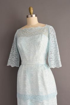 "Gorgeous vintage 1950s cocktail party dress in a wonderful icy blue color with a lovely lace overlay throughout. This vintage dress features a very flattering fitted bodice with bust darts, nipped waist, and a pencil skirt. Back zipper for closure. ✂------ M E A S U R E M E N T S ------- Best Fit: Medium Bust: 37.5\" Waist: 28.5/29\" Hips: 41.5\" Shoulders: 15.5\" Sleeves: 16\" Total Length: 43\" Material: lace Condition: Excellent vintage condition. Ready to wear. ☆ Layaway is available for th Light Blue Lace Dress With Fitted Bodice, Light Blue Fitted Lace Dress, Fitted 1950s Style Dress With Lace Trim, 1950s Style Fitted Dresses With Lace Trim, 1950s Fitted Lace Dress, 1950s Cocktail Party, 50s Dresses, Mint Blue, Cocktail Party Dress