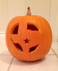 a carved pumpkin sitting on top of a white tile floor