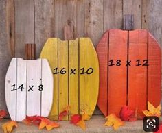 three wooden pumpkins sitting next to each other