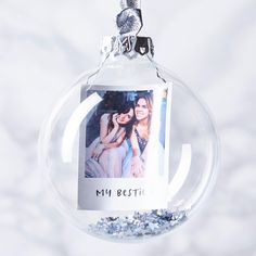 a glass ornament with a photo hanging from it