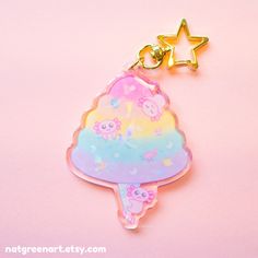 a keychain shaped like an ice cream sundae on a pink background with a star